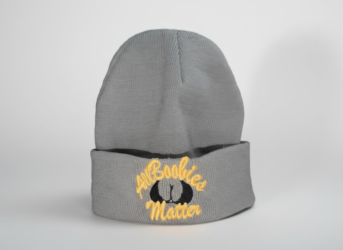 Gray beanie with 'All Boobies Matter" text on a white surface