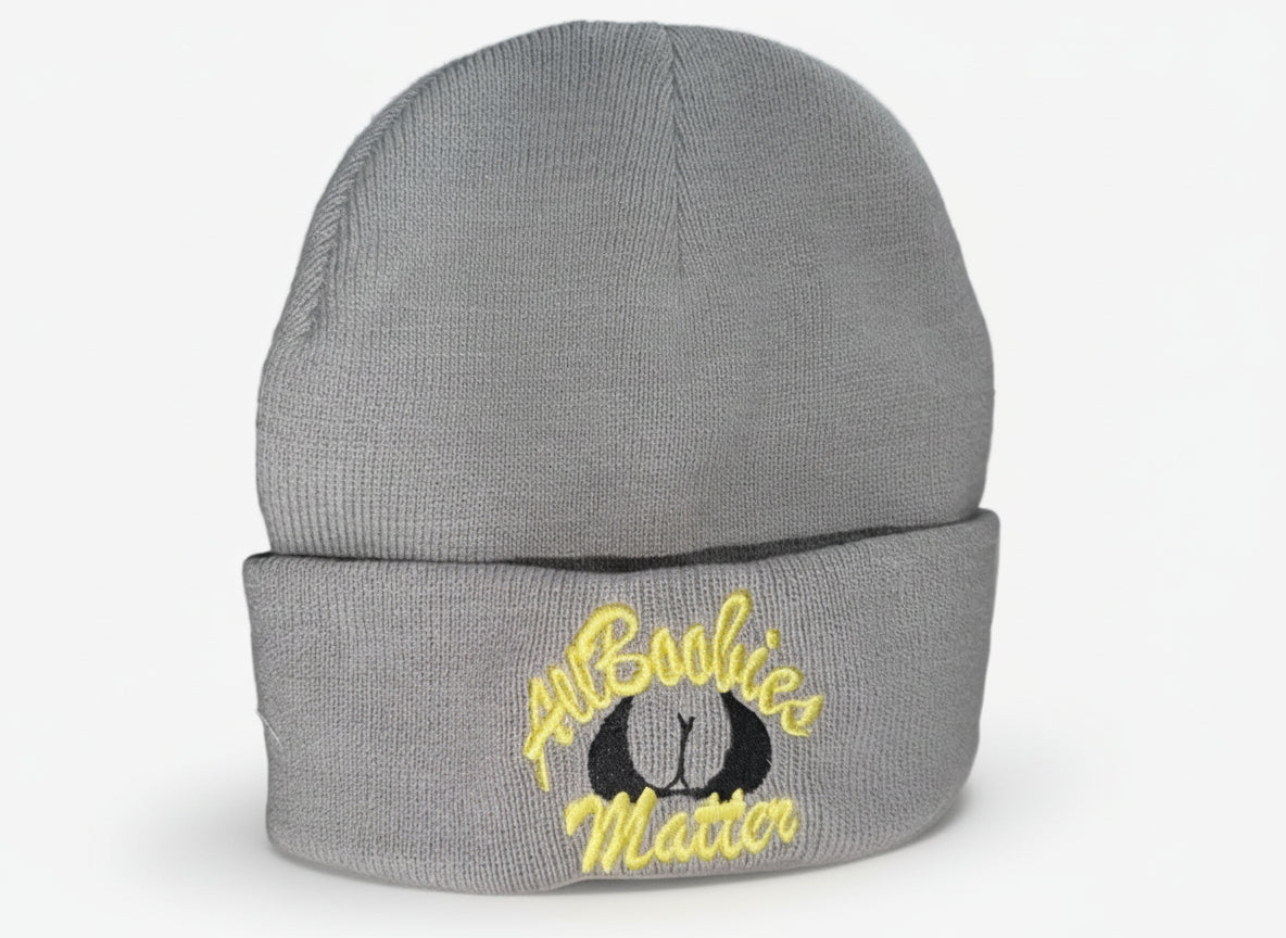 Gray beanie with 'All Boobies Matter' text on a white surface